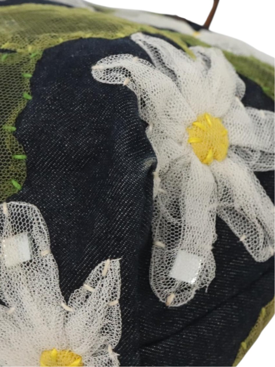 Close-up of a decorative item with floral patterns and tulle