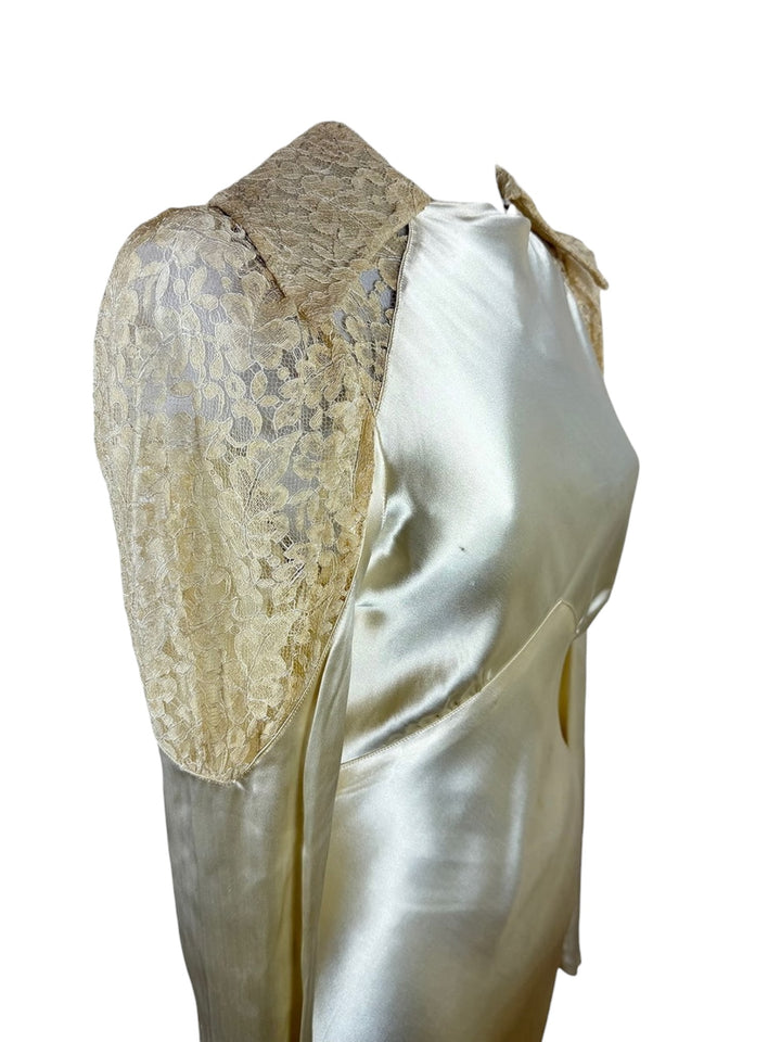 Vintage-style garment with lace detailing on a white background