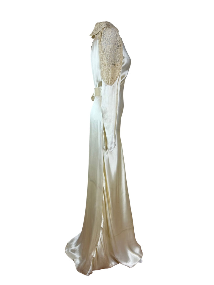 Elegant white evening gown with a fitted bodice and flowing skirt on a white background