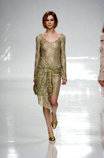 FW 2002 Blumarine fairycore runway gold dress Model wearing a gold dress on a runway with a white background