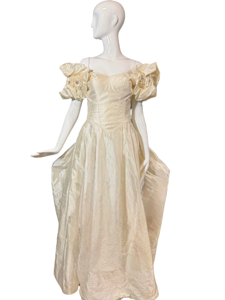 Close-up of the vintage Priscilla of Boston wedding gown silk taffeta fabric, highlighting the intricate floral puff sleeves and rosettes, perfect for a vintage wedding gown.