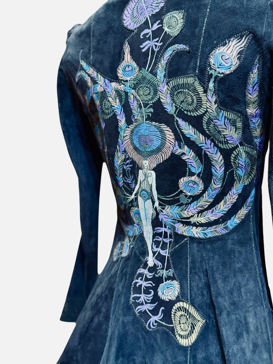 A close-up of a black suede 70's painted cavalli garment featuring intricate, colorful embroidery with blue, green, and purple details on the back, set against a plain light gray background.