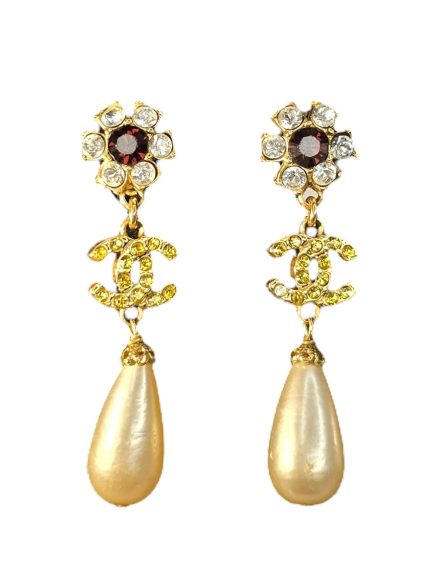 Gold Chanel earrings with pearl drops and gemstone accents on a white background