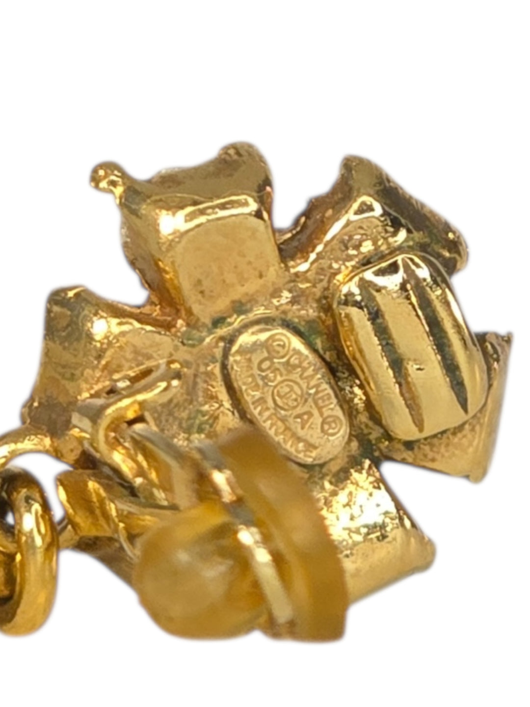 Gold charm shaped like a camera on a white background