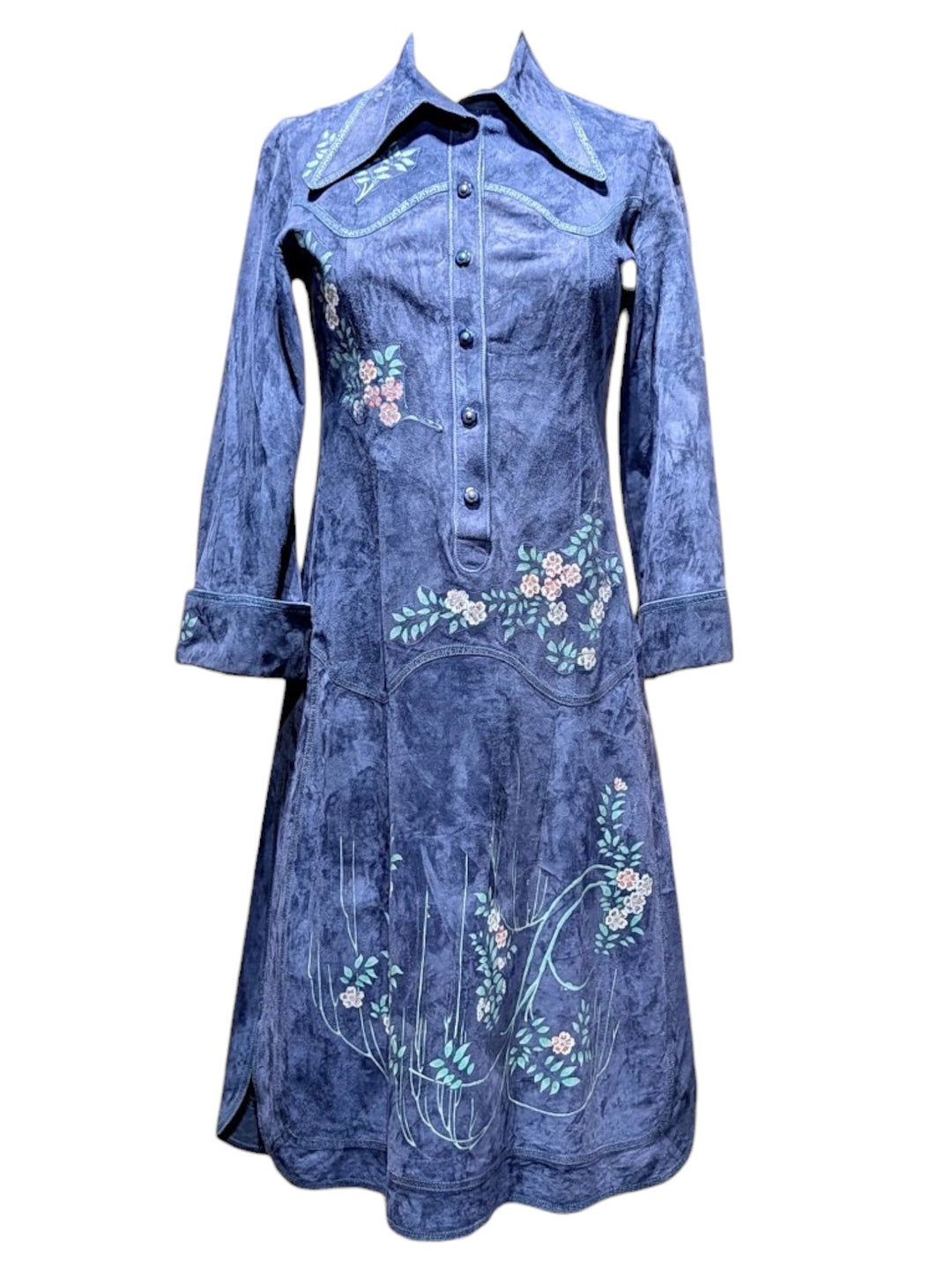 A blue denim long-sleeve button-up shirt dress with floral embroidery on the front, collar, and cuffs, shown against a plain white background. ROBERTO CAVALLI RERACKED VOGUE 1970'S PAINTED SUEDE COLLECTION RARE - FASHION HISTORY MET MUSEUM