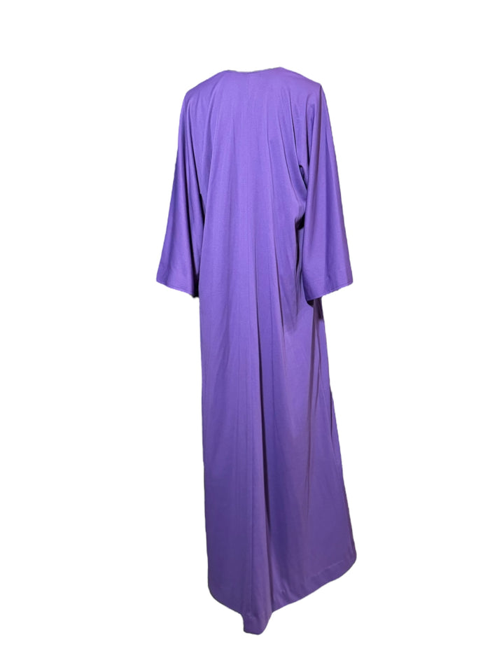 Vintage 1970s Halston purple jersey kaftan with deep V-neckline, wide sleeves, and flowing minimalist silhouette on mannequin