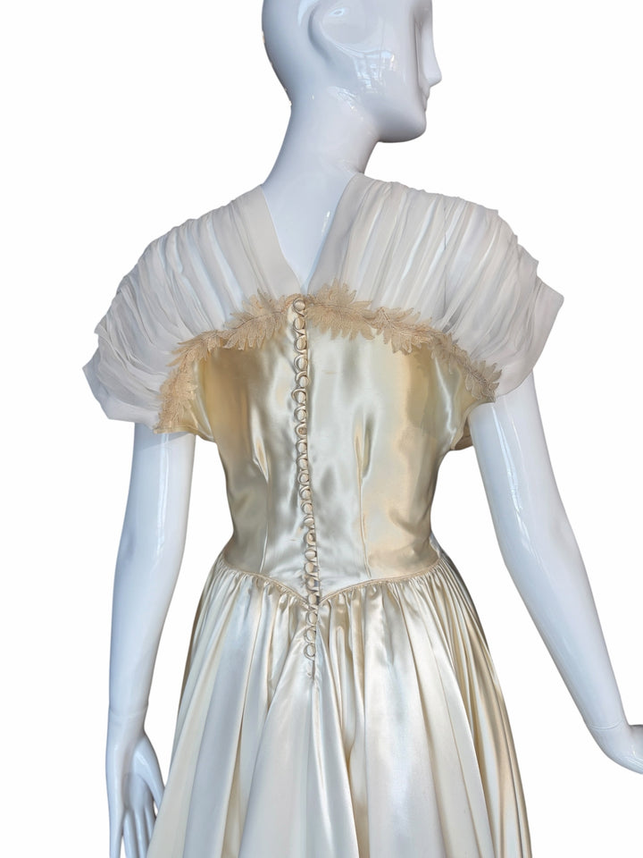 RERACKED vintage cream satin evening gown featuring pleated cap sleeves, lace trim, and a button-down back on a mannequin