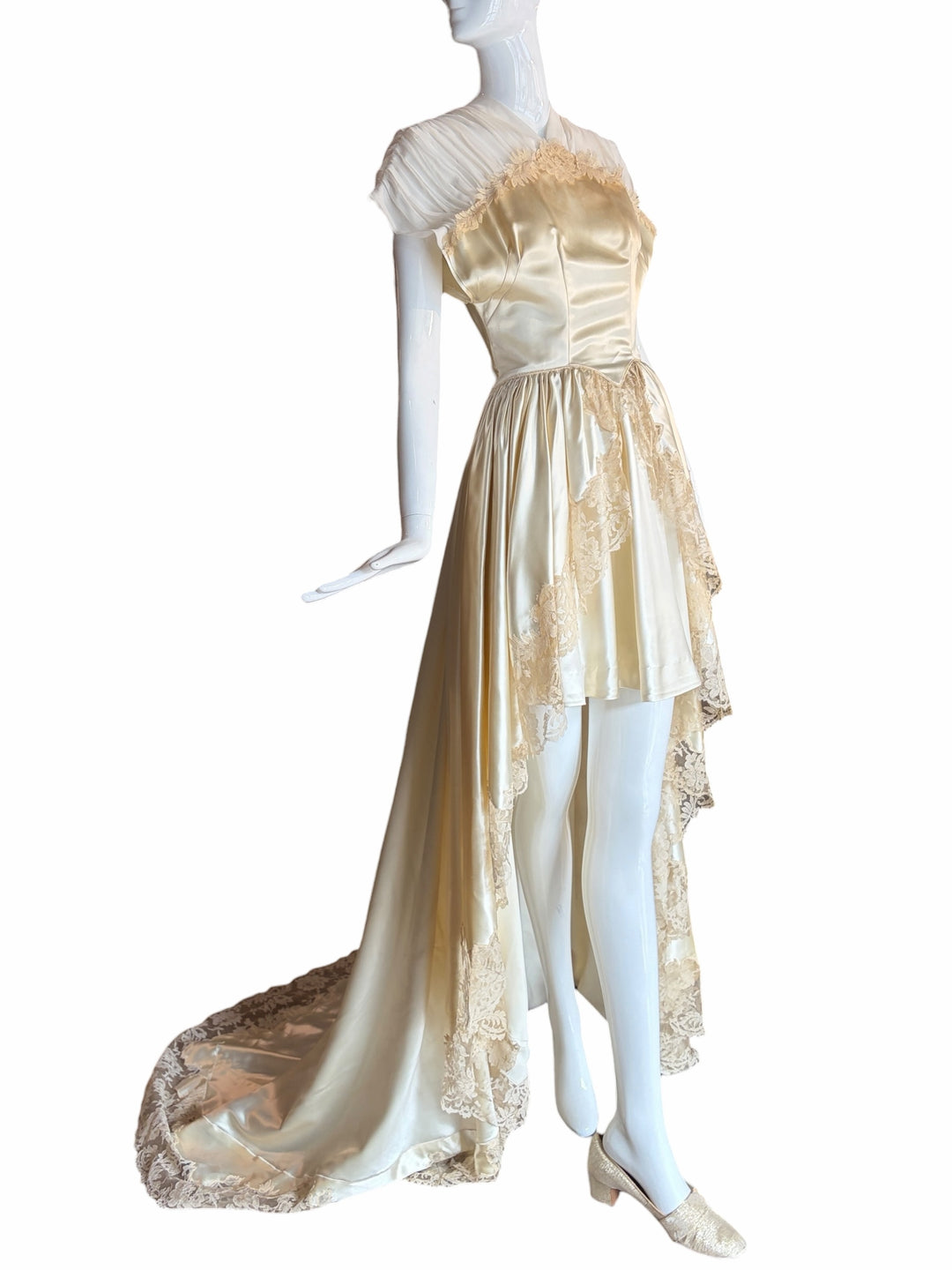 RERACKED vintage cream satin high-low evening gown with delicate lace trim, pleated cap sleeves, and a long train.