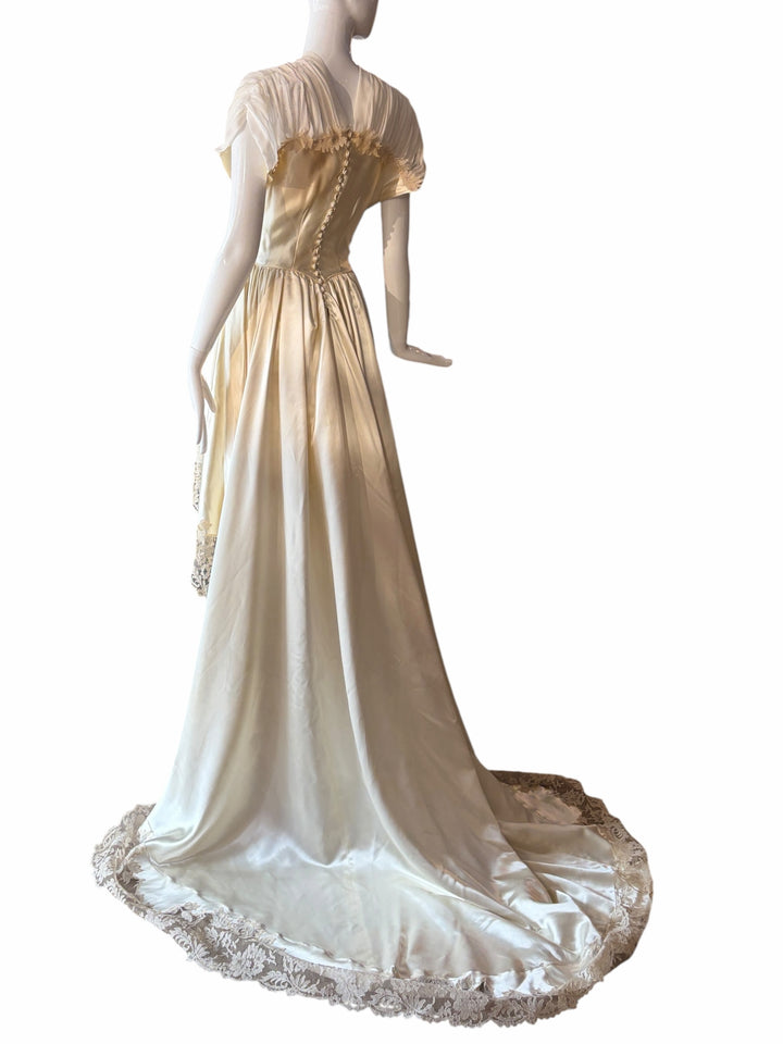 RERACKED vintage cream satin high-low evening gown with lace trim, pleated cap sleeves, and button-down back detail.