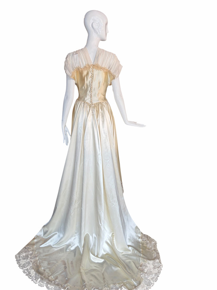 RERACKED vintage cream satin evening gown with lace trim, pleated cap sleeves, and button-down back on a mannequin