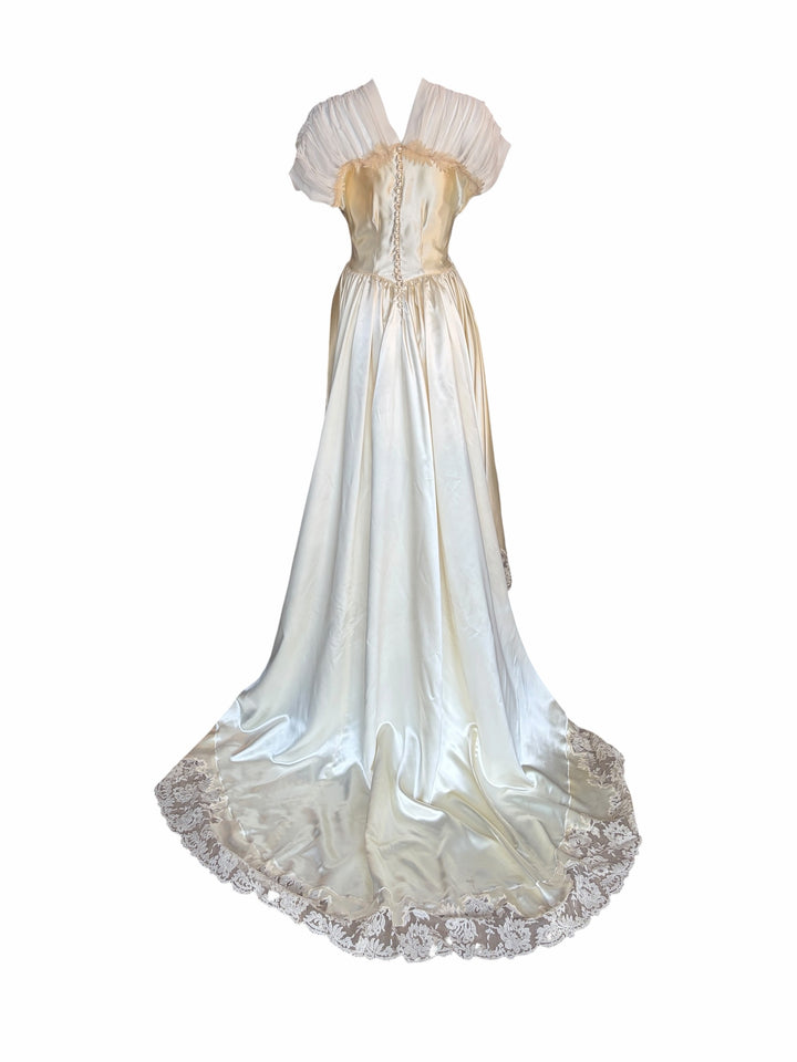 RERACKED vintage cream satin evening gown with high-low hem, lace trim, pleated cap sleeves, and button-up back.